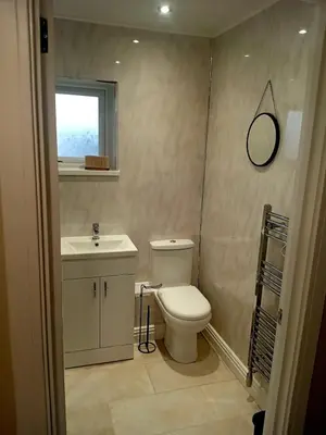 a bathroom with a toilet and a sink and a mirror at Martindale Close - 3 Bedrooms - Sleeps 5 in Whitehaven