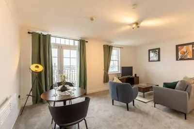 a living room with a couch and a table at 1 Bed Whitehaven Harbour-side Flat with Sea Views in Whitehaven
