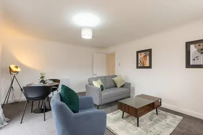 a living room with a couch and a table at Bright 1 Bed Harbour-side Apartment w Sea Views in Whitehaven