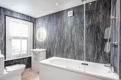a bathroom with a white tub and a toilet at No8 Peebles Retreat - Donnini Apartments in Ayr