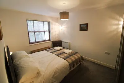 a bedroom with a bed and a window at Cedarfells, Hewetson Court, central Keswick with parking in Keswick