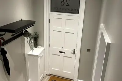 a white door in a hallway with a black counter at 26 Challoner Street, Cockermouth, CA13 9QS in Cockermouth
