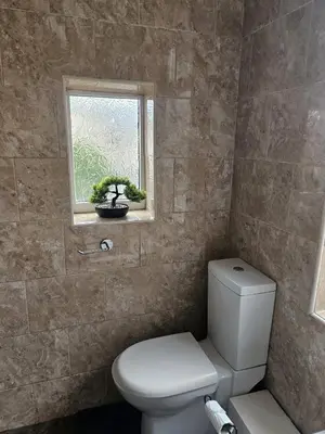 a bathroom with a toilet and a window at Acadia House Blyth in Moffat