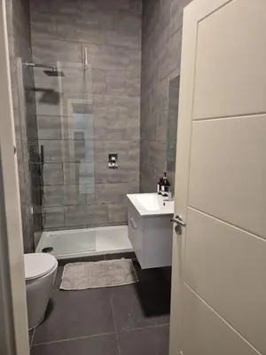 a bathroom with a toilet and a sink and a shower at Modern & Cozy Apartment in the Heart of the City in Moffat