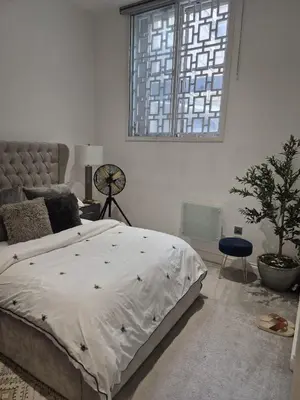 a bedroom with a large bed and a window at Modern & Cozy Apartment in the Heart of the City in Moffat