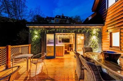 a patio with a table and chairs on a deck at Luxury Lodge 18 by Ashgrove Leisure in Moffat