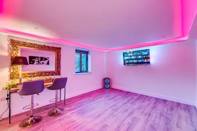 a pink room with a table and two chairs at Luxury Lodge 18 by Ashgrove Leisure in Moffat