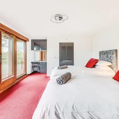 two white beds in a room with a red carpet at Luxury Lodge 18 by Ashgrove Leisure in Moffat