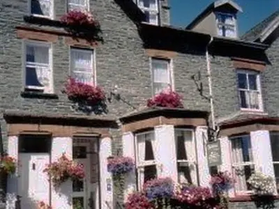a large brick house with flowers on the windows at Lindisfarne House in Keswick