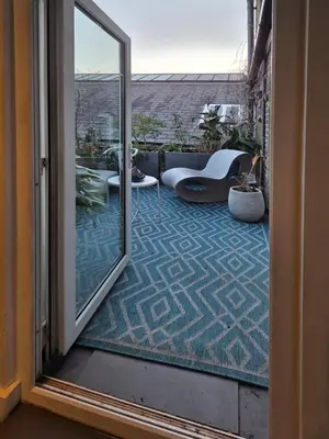 an open glass door to a balcony with a patio at Central London stylish 2-Bed House, with 2 terraces in Moffat