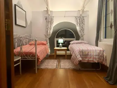a bedroom with two beds and a mirror at A Hidden Gem in Cornwall in Moffat