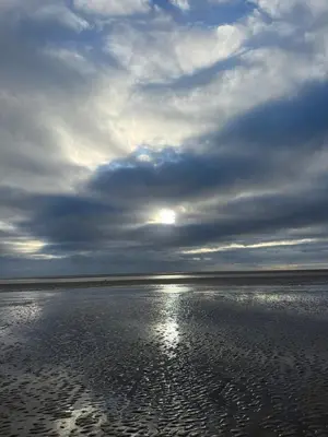 a cloudy sky over the water on a beach at Paws a while in Mainsriddle