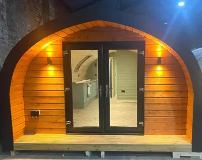 a small wooden room with an arched doorway at Pennygael in Lanark
