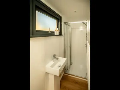 a bathroom with a sink and a shower at Laverock How Shepherds Hut with private hot tub in Seascale