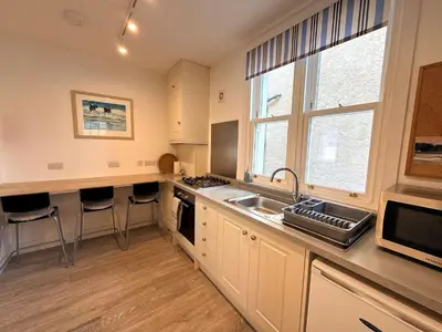 a kitchen with a sink and a counter top at Beautifully Presented Cosy Home in Kirkcudbright - Pass the Keys in Kirkcudbright