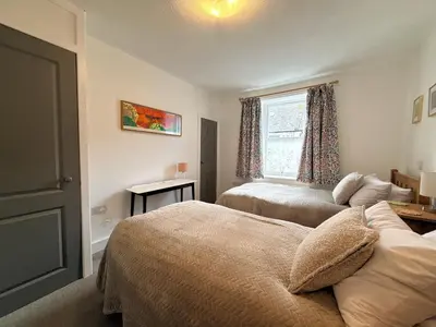a bedroom with two beds and a window at Beautifully Presented Cosy Home in Kirkcudbright - Pass the Keys in Kirkcudbright