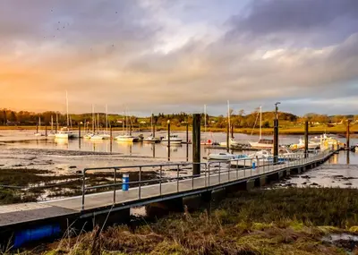 a dock with boats docked in a marina at Beautifully Presented Cosy Home in Kirkcudbright - Pass the Keys in Kirkcudbright