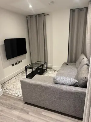 a living room with a couch and a flat screen tv at Colindale Condominium in Moffat