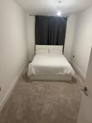 a bed in a small room with a window at Colindale Condominium in Moffat
