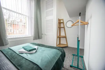 a room with a bed and a ladder next to a window at Newton Flat in Carlisle
