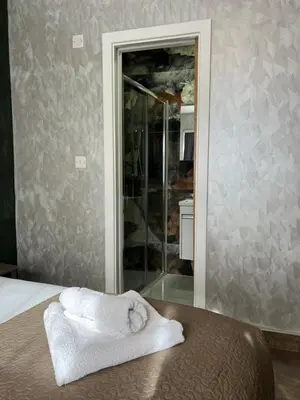 a bedroom with a bed with a towel on a table at Rest Inn Edmonton in Moffat