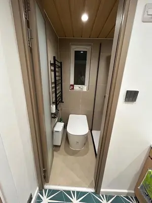 a small bathroom with a toilet and a sink at Baoyan Kingstong - 2 bedrooms in Moffat