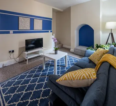 a living room with a couch and a tv at 3 Bedroom house In Gloucester in Moffat
