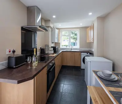 a kitchen with a sink and a counter with a dishwasher at 3 Bedroom house In Gloucester in Moffat