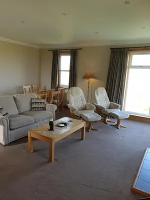 a living room with a couch and chairs and a table at Corsewall Lighthouse Hotel in Kirkcolm