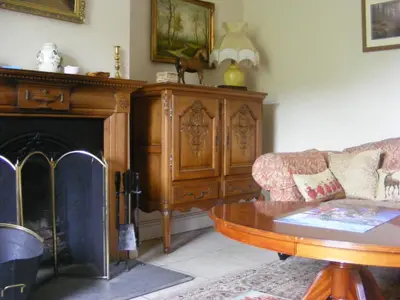 a living room with a couch and a table at The Dash Farmhouse in Bassenthwaite