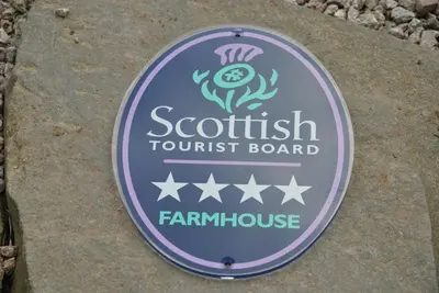 a sign for a seafood tourist board on a rock at Airds Farm Guest House in Castle Douglas