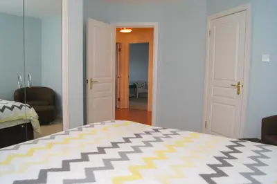 a bedroom with a bed and a living room at Wood Court, Troon in Troon