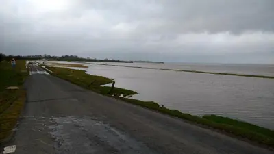 an empty road next to a body of water at Midtown Farm Bed & Breakfast in Easton