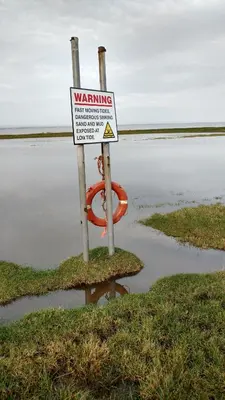 a warning sign in the middle of a body of water at Midtown Farm Bed & Breakfast in Easton