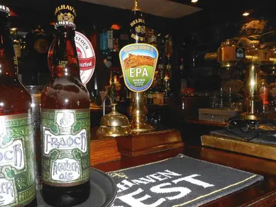 a bottle of beer sitting on top of a bar at The Ken Bridge Hotel & Campsite in New Galloway