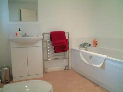 a bathroom with a sink and a tub and a toilet at Ballacowell in Sulby