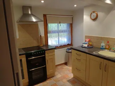 a kitchen with a sink and a stove at Ballacowell in Sulby