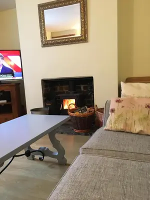 a living room with a couch and a fireplace at Ballacowell in Sulby