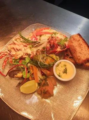 a plate of food with shrimp and vegetables on a table at Pond Cottage in Covington