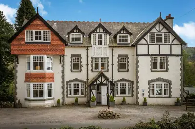 a large white and black house with a lot of windows at Stanley House in Eskdale