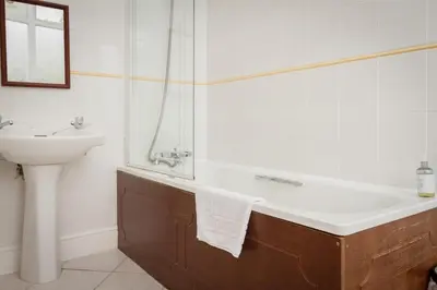 a bathroom with a sink and a bath tub and a sink at Stanley House in Eskdale