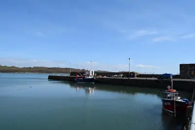 two boats docked at a dock in the water at Cladach in Garlieston