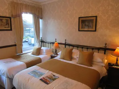 a hotel room with two beds and a window at Brookfield B&B Guest House in Keswick