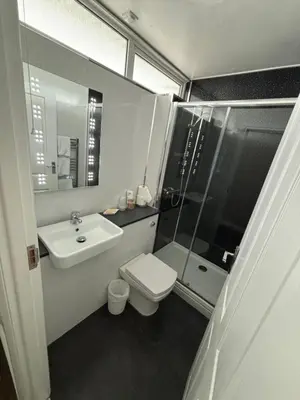 a bathroom with a toilet and a sink and a shower at Solway Lodge Hotel in Gretna Green