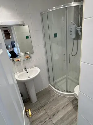 a bathroom with a sink and a shower at Solway Lodge Hotel in Gretna Green