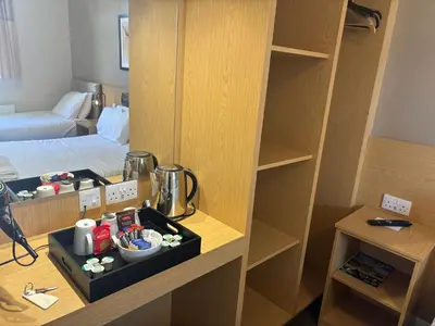 a room with a cupboard and a room with a bed at Solway Lodge Hotel in Gretna Green