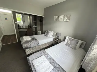 a hotel room with two beds and a couch at Solway Lodge Hotel in Gretna Green