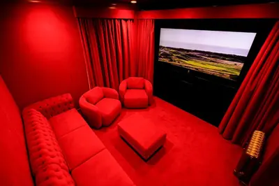 a red room with a red couch and a tv at Trump Turnberry in Turnberry