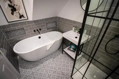 a bathroom with a white tub and a sink at The Loans Inn in Troon