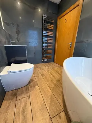 a bathroom with a white tub and a sink at The Ship Inn - Winner Best Hotel Experience 2024 Visit Scotland in Gatehouse of Fleet